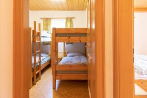 a room with several bunk beds in a house at Haus Obweg - Postalm in Abtenau