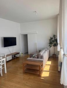 a living room with a couch and a table at La bulle dunkerquoise in Coudekerque-Branche