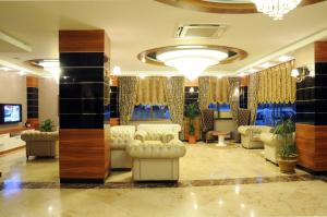 a lobby with couches and chairs in a building at Othello Hotel in Mersin