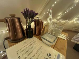 a table with a bottle of wine and flowers on it at Glamping Rincón de Lavanda in Texcoco de Mora