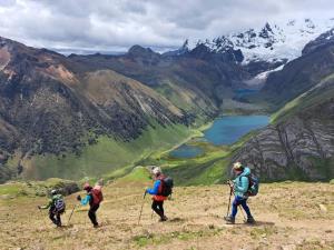 a group of people walking on top of a mountain at Perú Andina Tours & Hostel Amparo in Huaraz