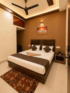 a bedroom with a bed and a ceiling fan at Sudama Palace - Free Temple Pass For Guests in Ayodhya