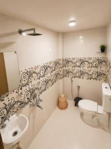 a bathroom with a toilet and a sink at Sudama Palace - Free Temple Pass For Guests in Ayodhya