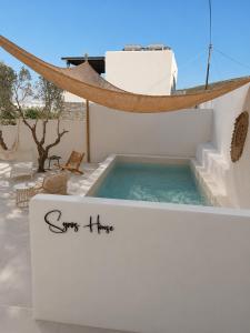 a sign for a plunge pool on a white house at Syros-house in Azolimnos Syros