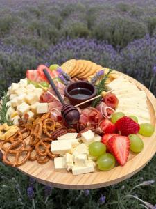 a plate of cheese and fruit on a table at Glamping Rincón de Lavanda in Texcoco de Mora