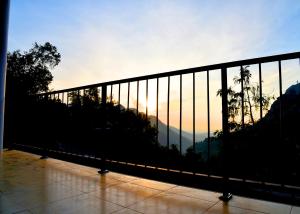 a view of the sunset from a balcony at Super View Home Stay in Ella