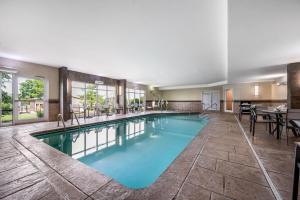 a pool with blue water in a hotel room at AmericInn by Wyndham Fairfield in Fairfield