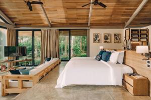 a bedroom with a large white bed and large windows at Villa Escape Burasari in Phuket +48 photos