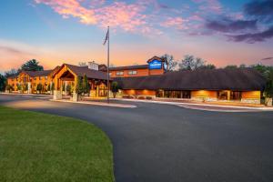 a large building with a flag on top of it at AmericInn by Wyndham Wisconsin Dells in Wisconsin Dells