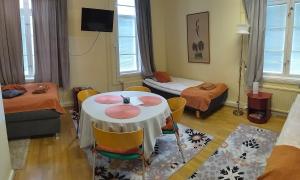 a small room with a table and chairs and a bedroom at Hostelli Marja in Mikkeli