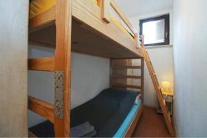 a bedroom with two bunk beds and a desk at APARTMANI DELAS in Pješčana Uvala