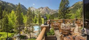 a resort balcony with tables and chairs and a pool at Everline Resort and Spa, Lake Tahoe in Olympic Valley