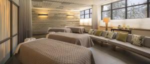 a hospital room with three beds and windows at Everline Resort and Spa, Lake Tahoe in Olympic Valley