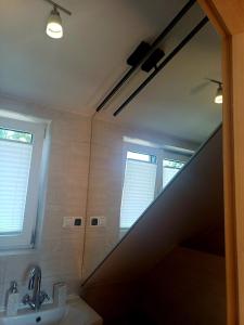 a bathroom with a sink and a large mirror at Noclegi Tomaszkowo in Tomaszkowo +38 photos