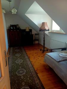 a attic room with a bed and a lamp at Noclegi Tomaszkowo in Tomaszkowo