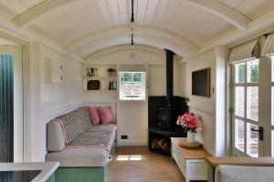 a living room with a couch and a fireplace at Hornbeam Holt in Broadway