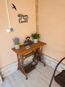 a wooden table with potted plants on a wall at Apartment The Garden Ruse, Private Garden & Free Parking in Ruse