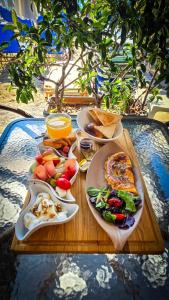 a table with plates of food on top of it at Costa Mare Rooms in Paralia Katerinis