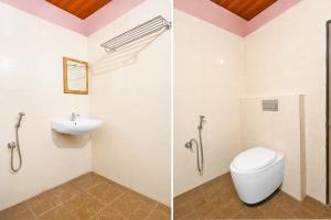 a bathroom with a toilet and a sink at Collection O Tennati Park Vizag Beach Formerly B Square Villa in Visakhapatnam