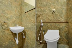 a bathroom with a toilet and a sink at Hotel O Abbigere Lakeview Bangalore Formerly Shree Venkateshwar Atithi Comforts in Chik Bānavar