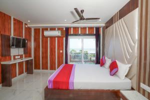 a bedroom with a large bed and a window at TN RESORTS in Mandarmoni +83 photos