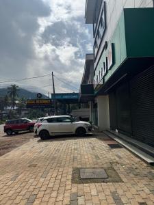 a white car parked in front of a building at Regal residency in Perintalmanna