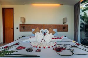 a bed with two swans made out of towels at Candidasa Hills in Candidasa +28 photos
