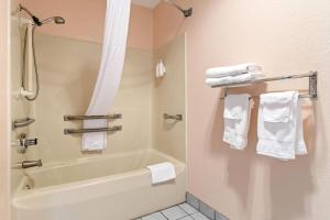 ein Badezimmer mit Badewanne und Handtüchern in der Unterkunft Super 8 by Wyndham Bourbonnais/Kankakee Area in Bourbonnais + 26 Fotos