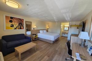 a hotel room with a bed and a couch at Days Inn by Wyndham Alhambra CA in Alhambra