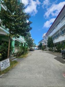 an empty street in front of some buildings at White Beach Resort Bar & Restaurant in Puerto Galera