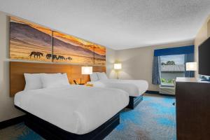 a hotel room with two beds and a window at Days Inn & Suites by Wyndham Ridgeland in Ridgeland +41 photos