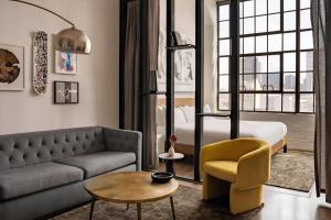 a living room with a couch and a bed at The Heid Lofts by Reside, a Wyndham Residence in Philadelphia