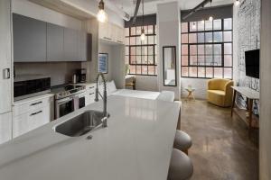 a kitchen with a sink and a counter top at The Heid Lofts by Reside, a Wyndham Residence in Philadelphia
