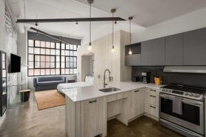 a kitchen with a sink and a stove at The Heid Lofts by Reside, a Wyndham Residence in Philadelphia +40 photos