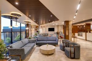 a living room with couches and a table at Keys Lite by Lemon Tree Hotels, Ajmer in Ajmer