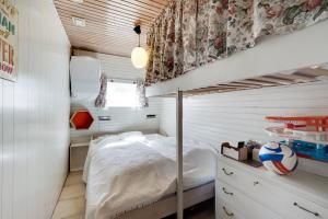 a bedroom with a bed in a small room at Cottage With A View in Roslev