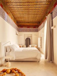 a bedroom with a large bed with a wooden ceiling at Riad Djannaat Exceptional private riad pool staff in Marrakesh