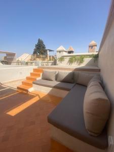 a couch sitting on the side of a building at Riad Djannaat Exceptional private riad pool staff in Marrakesh