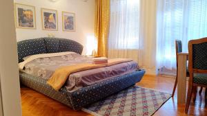 a bedroom with a bed in the middle of a room at Vila Sentić in Vranje
