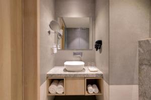 a bathroom with a sink and a mirror at Keys Lite by Lemon Tree Hotels, Ajmer in Ajmer +36 photos