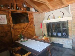 a dining room with a table and a fireplace at Country House Speedy in Komiža