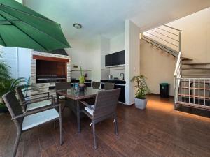 a living room with a dining room table and chairs at Tourist House in Santa Cruz de la Sierra