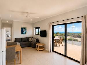 a living room with a couch and a table at Explorers Roost in Kalbarri