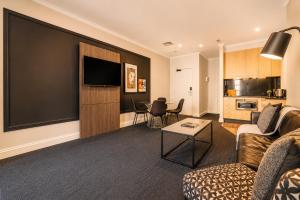 a living room with a couch and a table at Stylish CBD 1BR - Gym & Lounge - Next to Chinatown in Melbourne