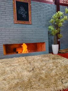 a large pile of hay in front of a fireplace at The Joglo Sekar Munduk in Pabean Buleleng