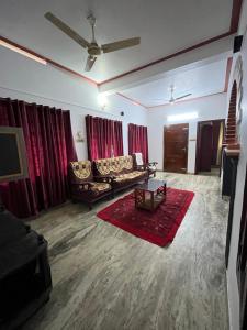 a living room with a couch and red curtains at Dragster Heritage Villa in Māla
