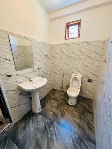 a bathroom with a sink and a toilet at G Lake Guest House in Mahiyangana
