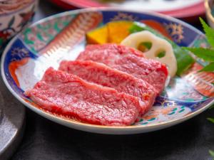 a plate of meat and vegetables on a table at Yufuin Yasuha in Yufu