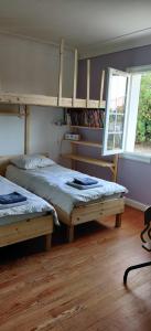 a bedroom with two beds and a window at Maison au bord de dune et océan in Labenne