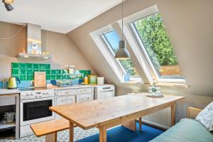 a kitchen with a wooden table in a room at Das Falken Nest in Eisenbach